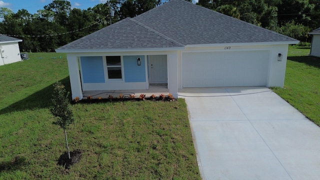 view of front of house with a garage and a front lawn