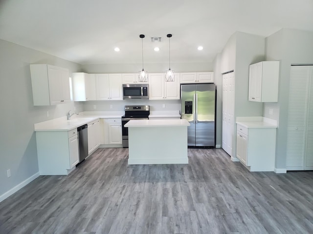 kitchen with pendant lighting, a center island, sink, white cabinetry, and stainless steel appliances