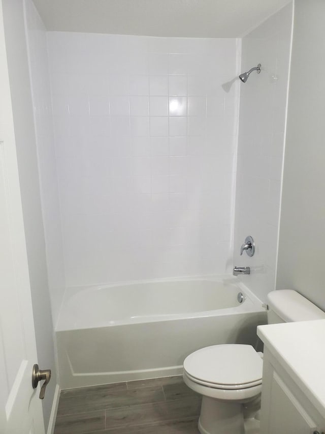 full bathroom featuring toilet, vanity, tub / shower combination, and hardwood / wood-style flooring