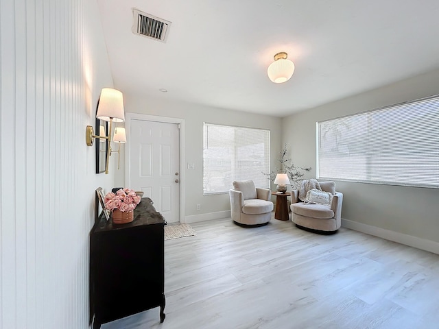 sitting room with hardwood / wood-style flooring