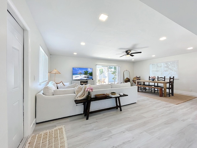 living room with ceiling fan and light hardwood / wood-style floors