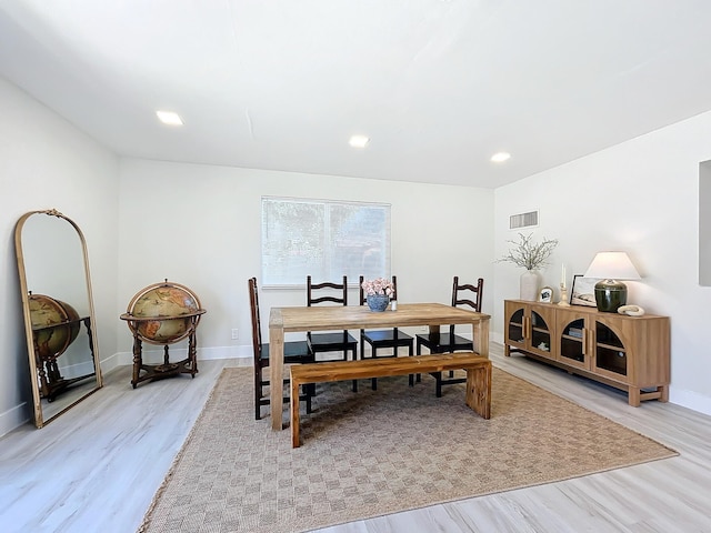 dining space with light hardwood / wood-style flooring