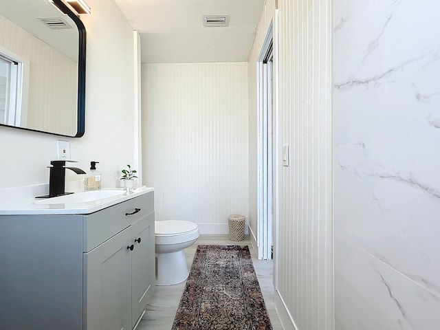 bathroom featuring vanity and toilet