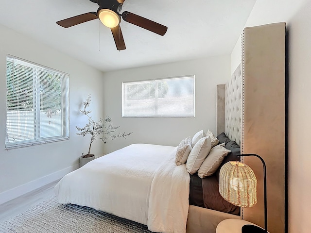 bedroom with ceiling fan and wood-type flooring