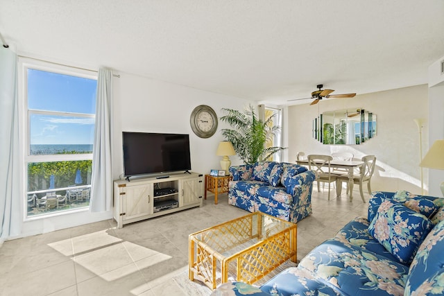 tiled living room with ceiling fan