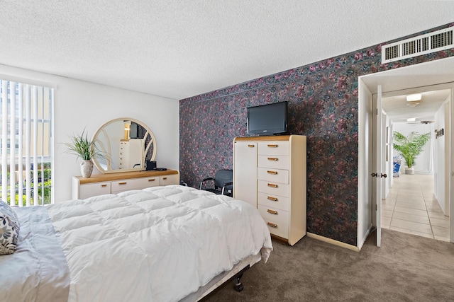 carpeted bedroom featuring a textured ceiling