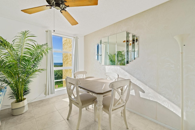 dining room with a wealth of natural light, light tile patterned floors, and ceiling fan