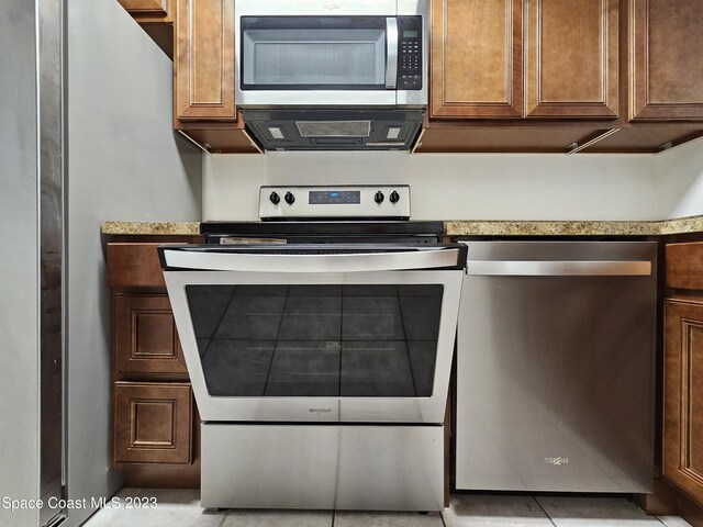 kitchen featuring light tile patterned floors and appliances with stainless steel finishes