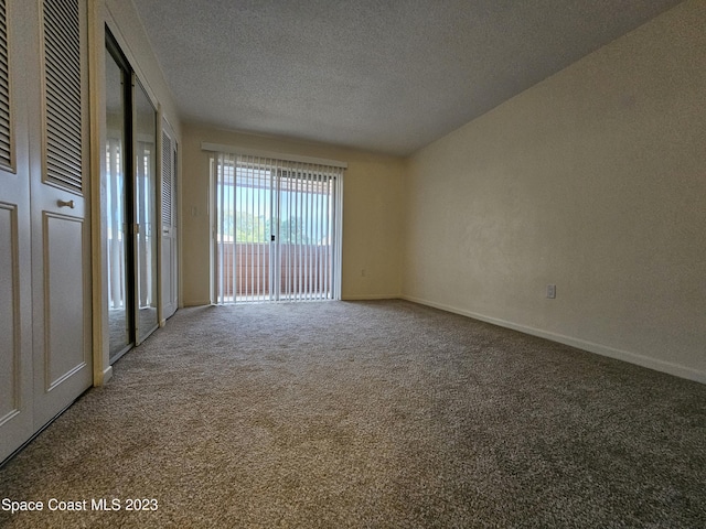 empty room featuring carpet flooring and a textured ceiling