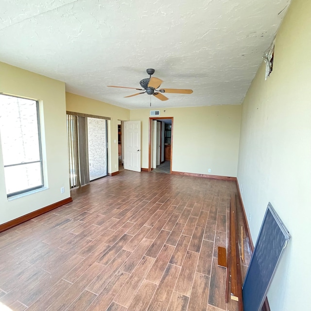 unfurnished living room with wood-type flooring, a textured ceiling, and ceiling fan