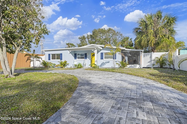 ranch-style home with a front lawn