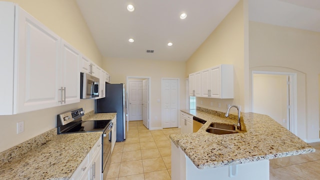 kitchen featuring light stone countertops, white cabinetry, sink, stainless steel appliances, and vaulted ceiling