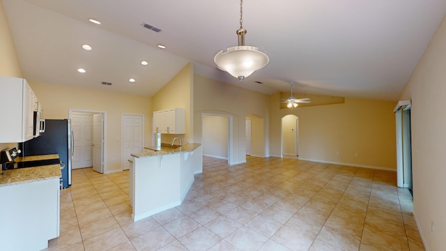 kitchen with ceiling fan, light stone countertops, white cabinetry, and hanging light fixtures