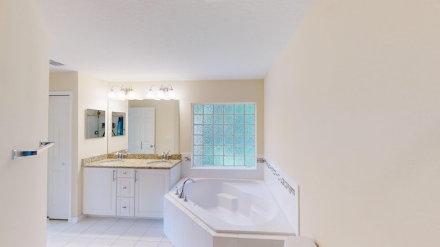 bathroom with vanity, tiled bath, and tile patterned floors