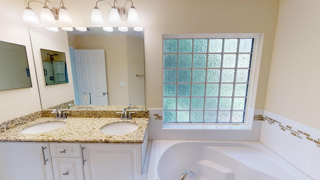 bathroom with a bath and vanity