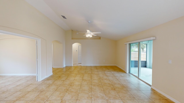 spare room with ceiling fan, light tile patterned floors, and vaulted ceiling