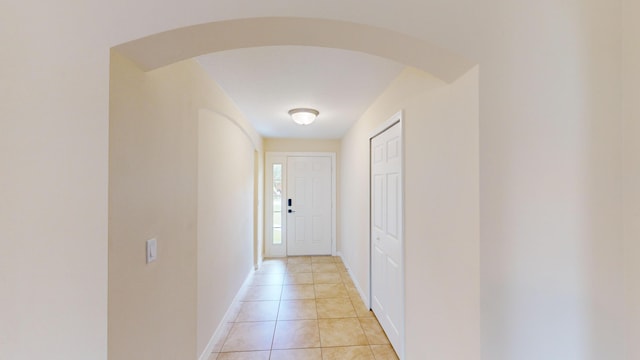 corridor featuring light tile patterned floors