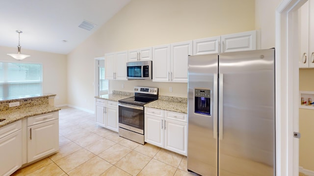 kitchen with white cabinets, appliances with stainless steel finishes, decorative light fixtures, and light tile patterned floors