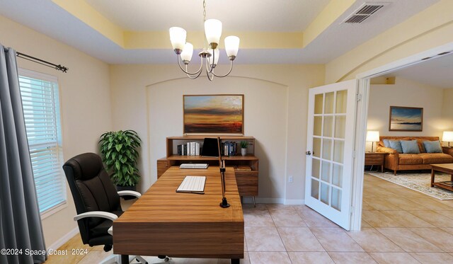 tiled office space with french doors, a raised ceiling, and a notable chandelier