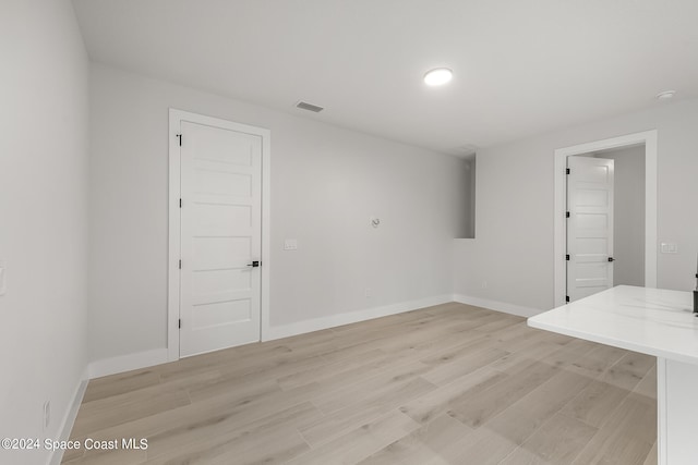 unfurnished room with light wood-type flooring