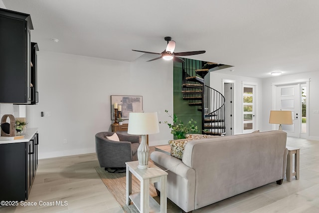 living room with ceiling fan and light hardwood / wood-style floors