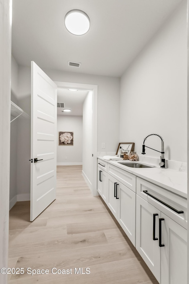 bathroom with hardwood / wood-style floors and vanity