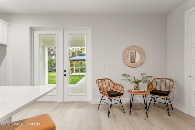 doorway with french doors and light hardwood / wood-style flooring