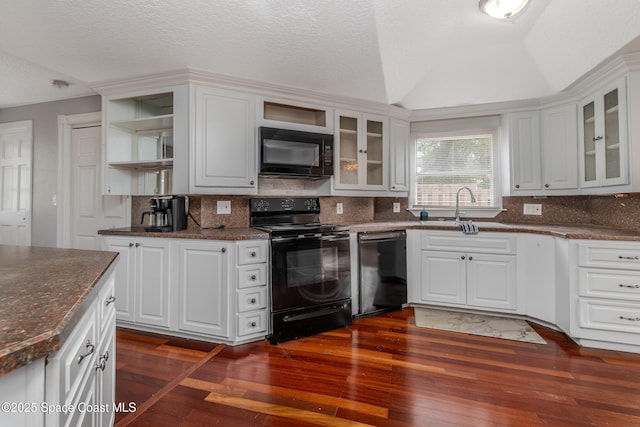 kitchen featuring dark hardwood / wood-style flooring, sink, black appliances, white cabinetry, and lofted ceiling