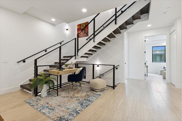 stairs with wood-type flooring