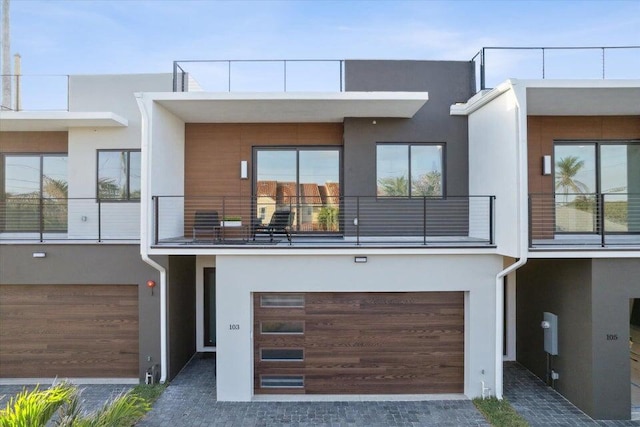 view of front of property with a balcony and a garage