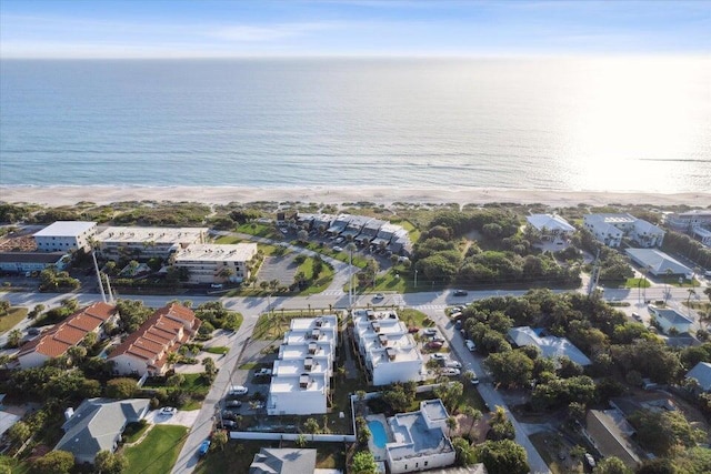 drone / aerial view featuring a water view and a view of the beach