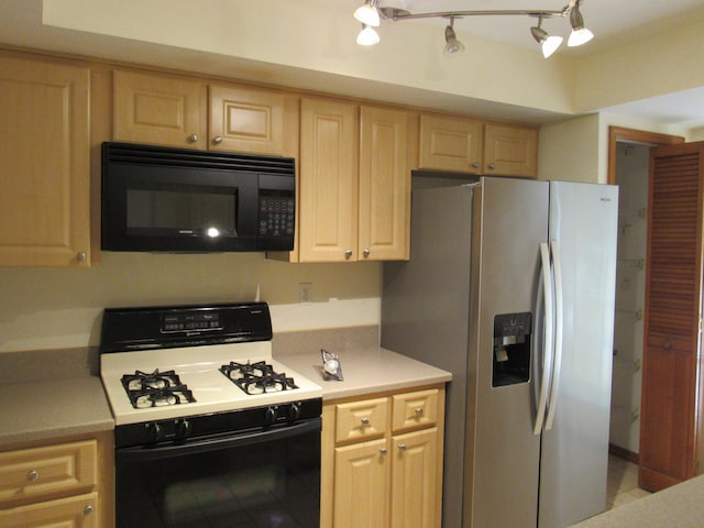 kitchen featuring stainless steel fridge, white gas range, and light brown cabinets