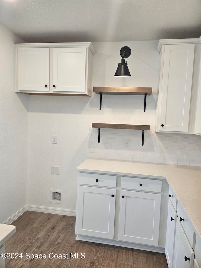 laundry room with cabinets and dark hardwood / wood-style flooring