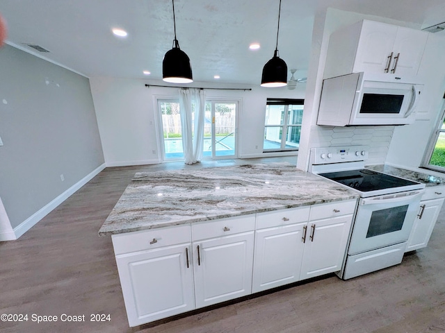 kitchen featuring pendant lighting, white appliances, light wood-type flooring, tasteful backsplash, and white cabinetry