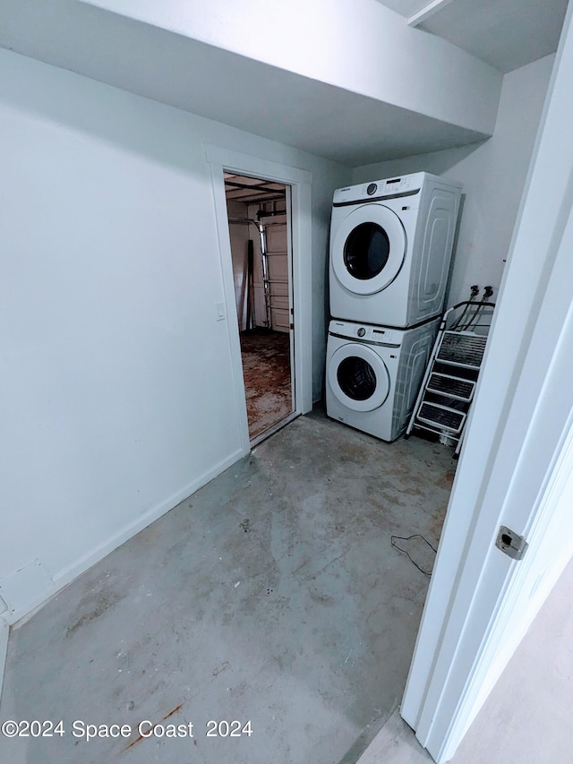 clothes washing area with stacked washer and dryer