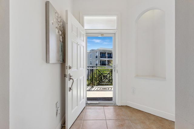 doorway to outside featuring a wealth of natural light and light tile patterned floors