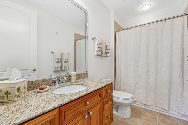 bathroom with vanity, tile patterned floors, and toilet