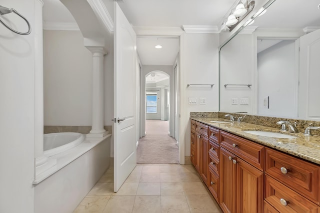 bathroom featuring a tub, tile patterned flooring, ornamental molding, and vanity