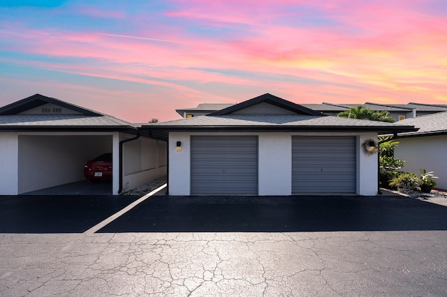 view of garage at dusk