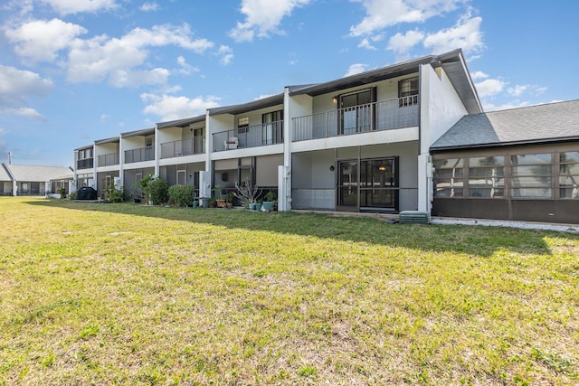 rear view of property with a yard