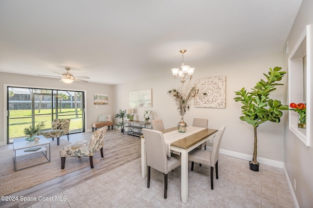 dining room with ceiling fan with notable chandelier