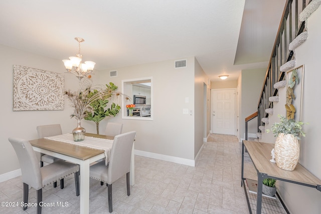 dining space featuring an inviting chandelier