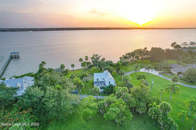 aerial view at dusk with a water view