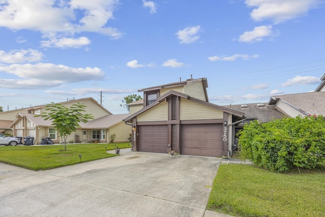 view of front of house with an attached garage, driveway, and a front yard