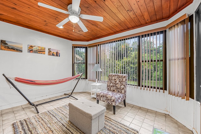 living area with wood ceiling, ceiling fan, and light tile patterned floors