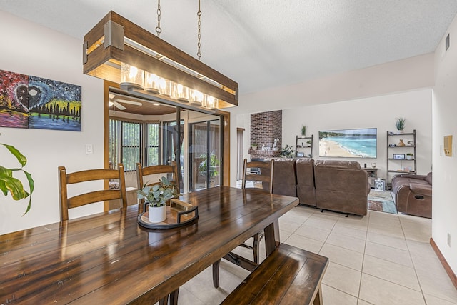 dining room featuring a textured ceiling and light tile patterned floors