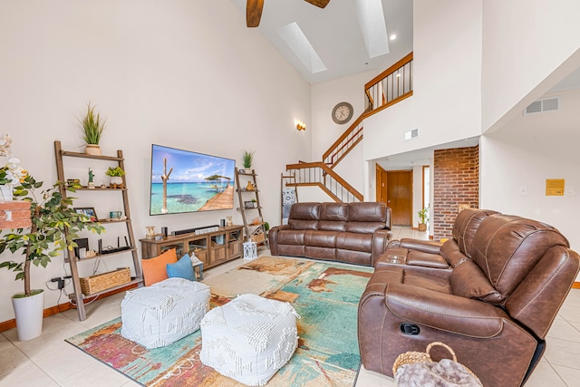 living room featuring light tile patterned floors, brick wall, high vaulted ceiling, and ceiling fan