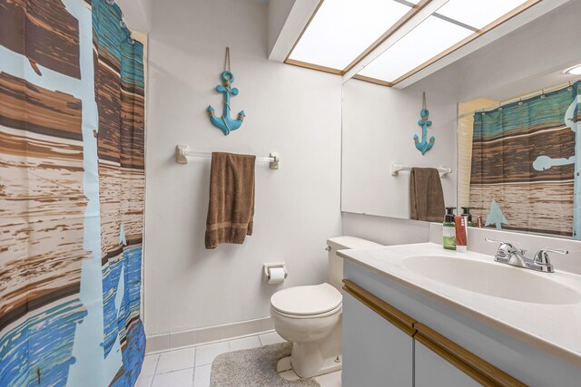 bathroom with vanity, toilet, and tile patterned floors