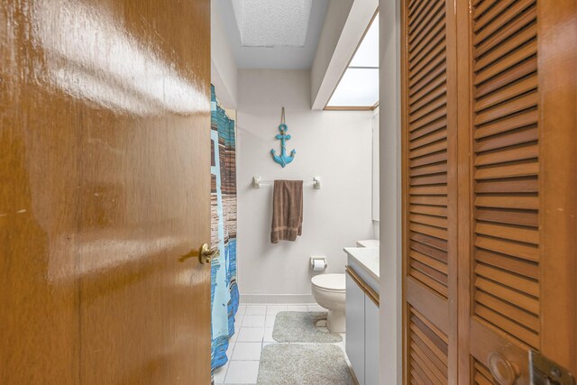 bathroom with vanity, tile patterned flooring, and toilet