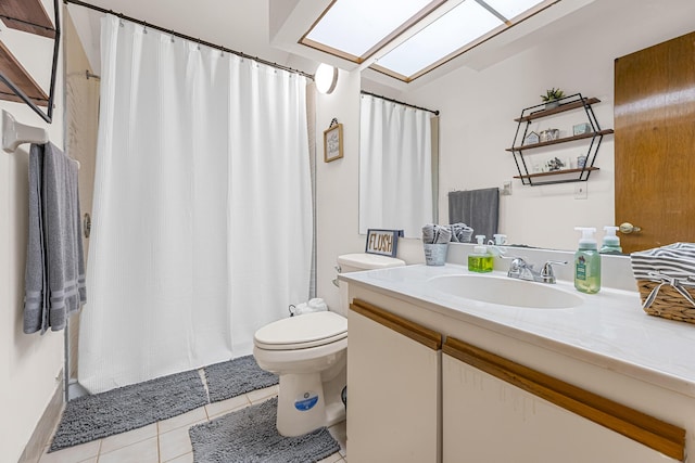 full bathroom with a skylight, curtained shower, toilet, vanity, and tile patterned floors